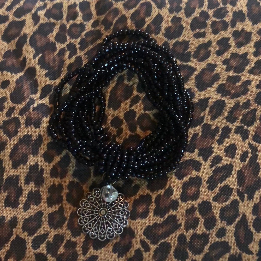Multi strand black bead with silver charm accent